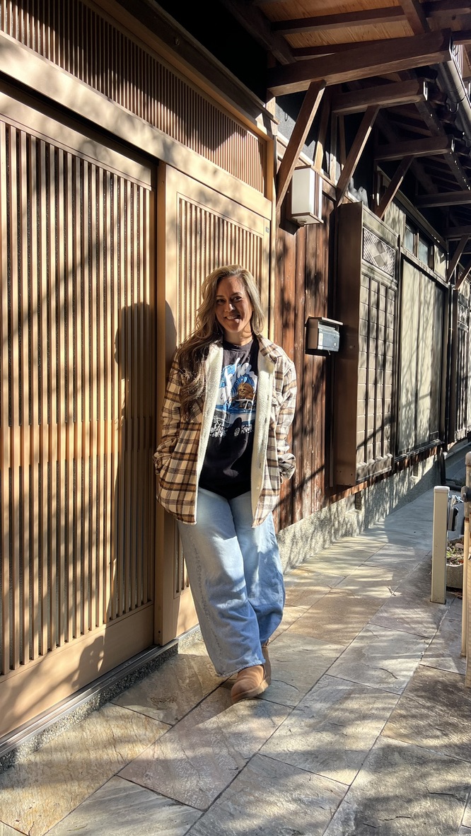 Brandy standing outside a traditional wooden Japanese building
