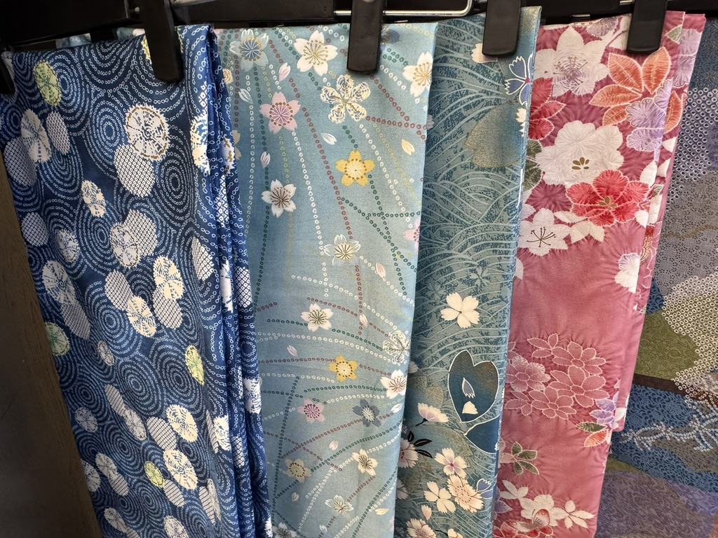 Blue and pink Japanese kimono fabrics hanging on clips